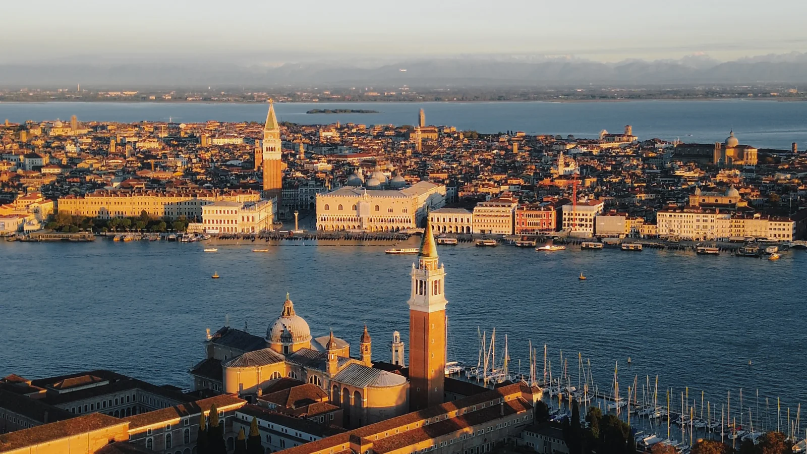 Aerial view at sunrise over San Giorgio Maggiore with St Mark's and the Doge's Palace beyond