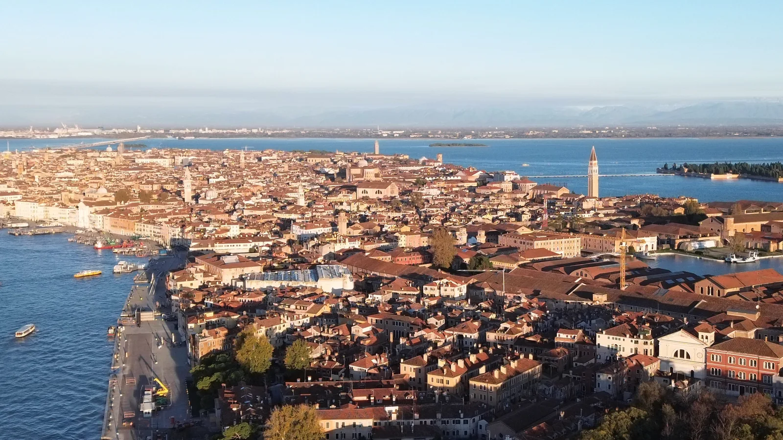 Aerial view across the rooftops of Venice toward the Arsenale and the open lagoon